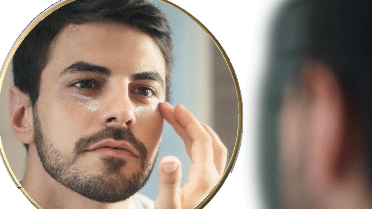 Men's make up being applied in the mirror