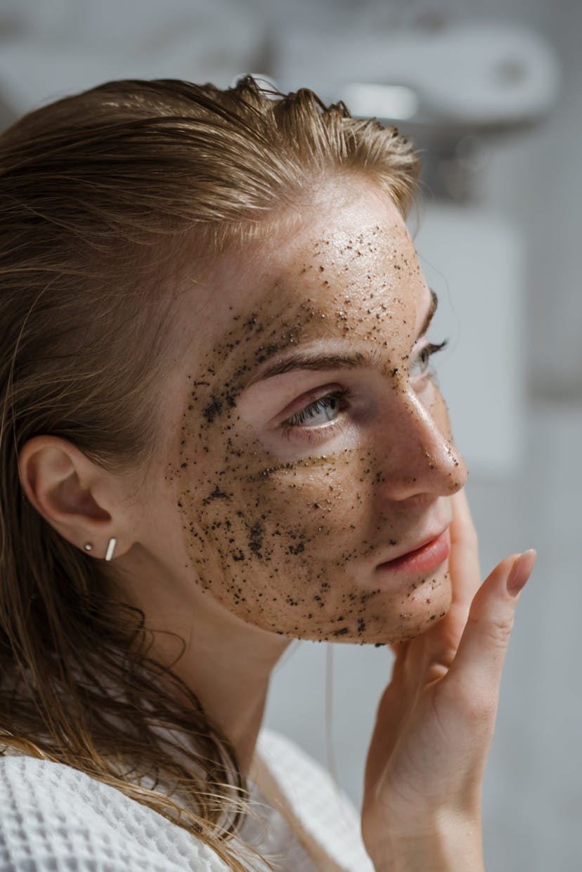 Woman With Coffee Scrub On Face
