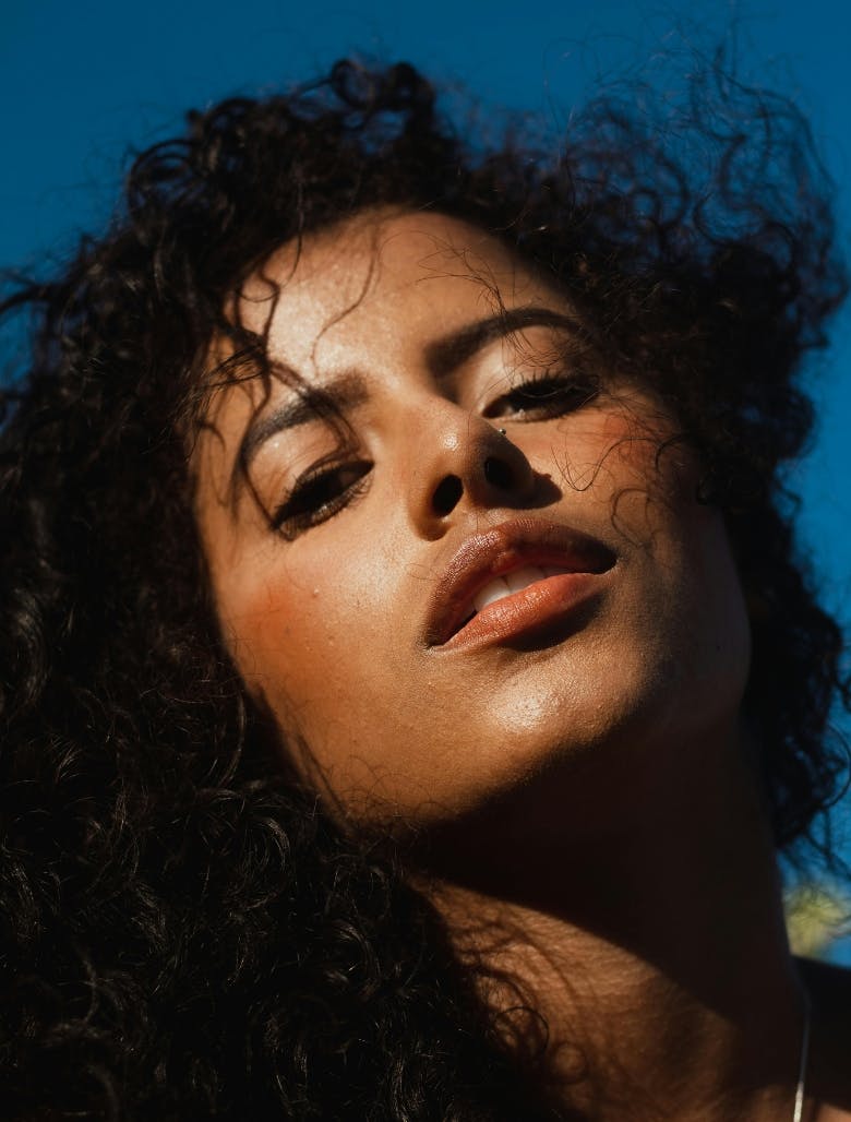 Woman with dewy skin and curly hair