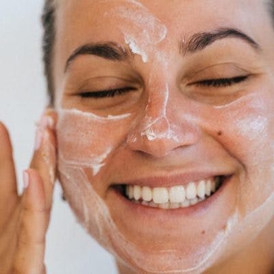 woman applying moisturiser