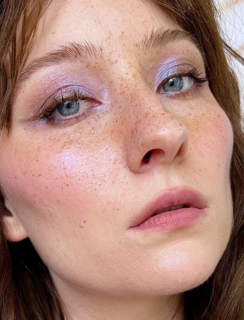 Girl with blue eyes wearing lilac eyeshadow