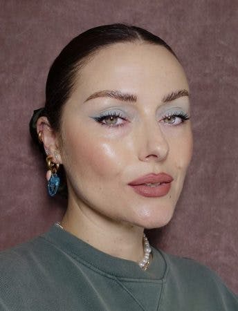 brunette woman with green eyes and blue eyeshadow