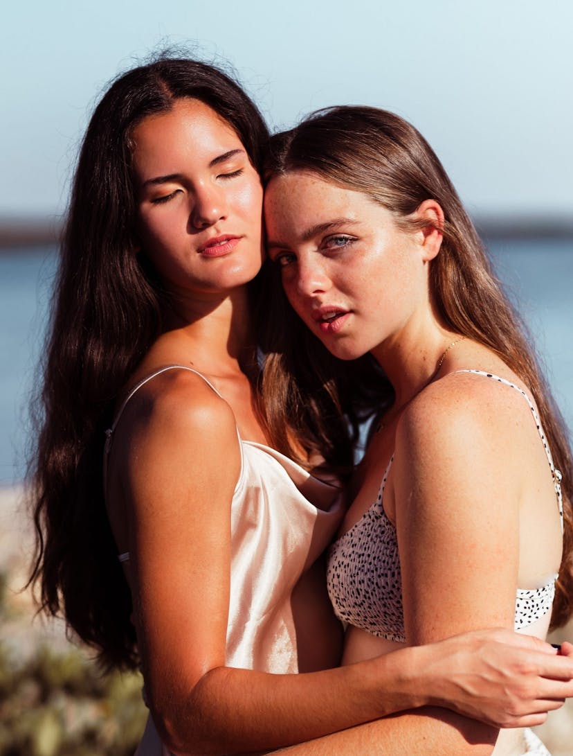 Two girls in swimwear embracing