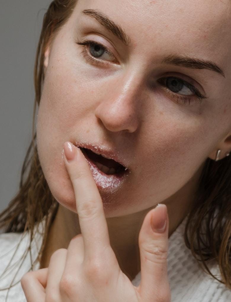 woman using a lip scrub