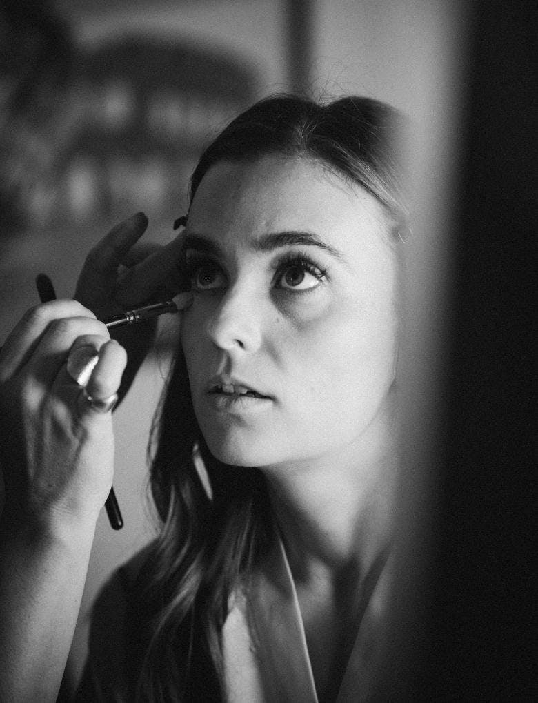 woman getting her make-up done