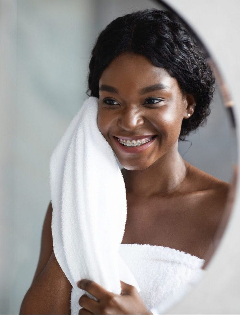 How To Shrink Enlarged Pores afro woman after face wash towel