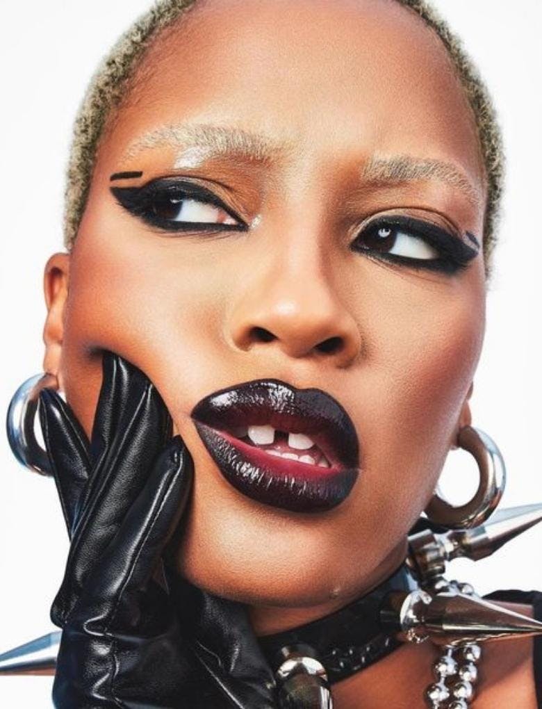 Model wearing black lipstick with gloss