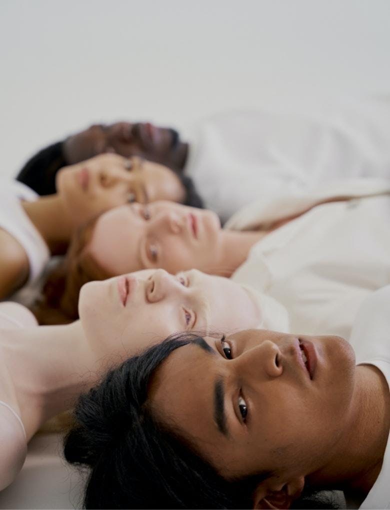 attractive group of people post glow-up lying down next to each other 