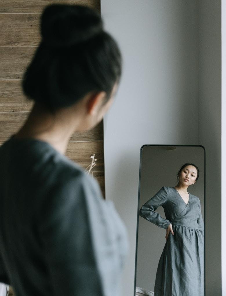 woman looking into the mirror