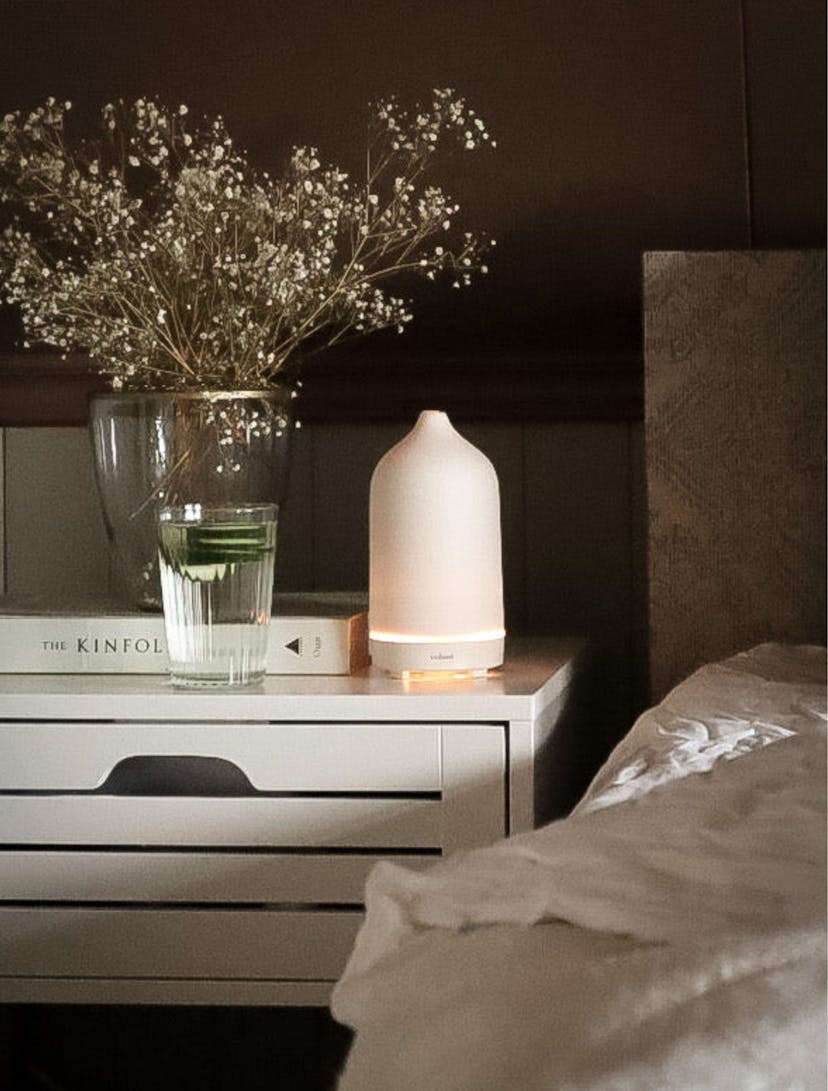 Diffuser on a bedside table scenting the room