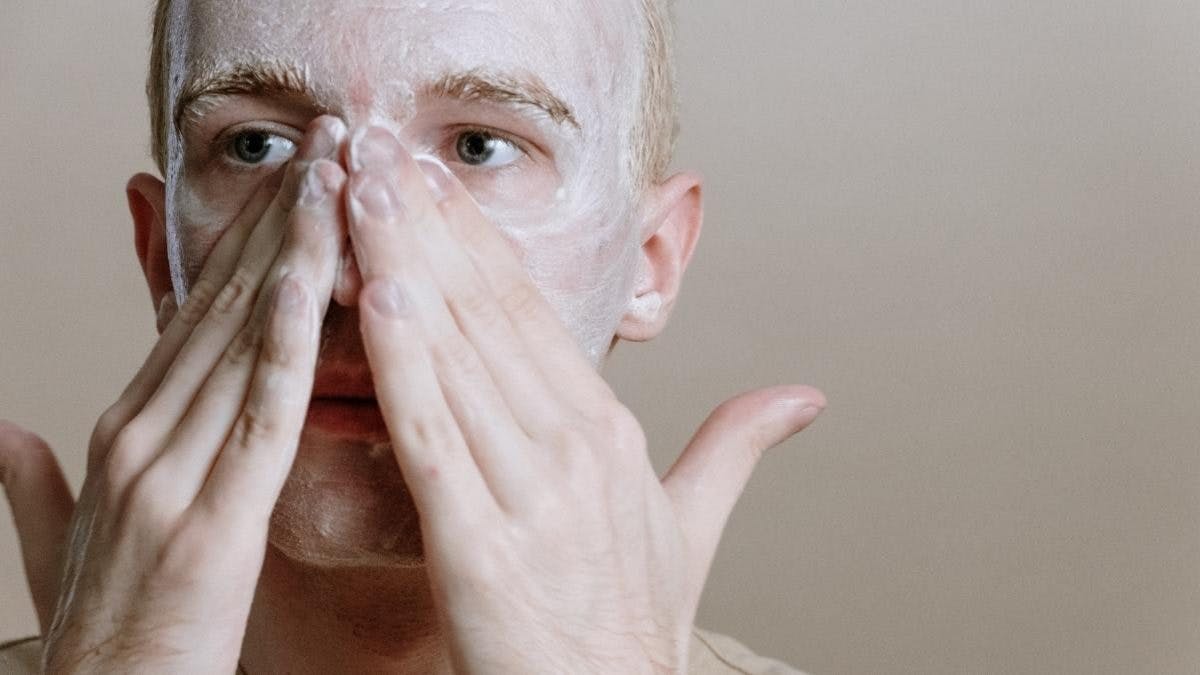 man applying a face mask
